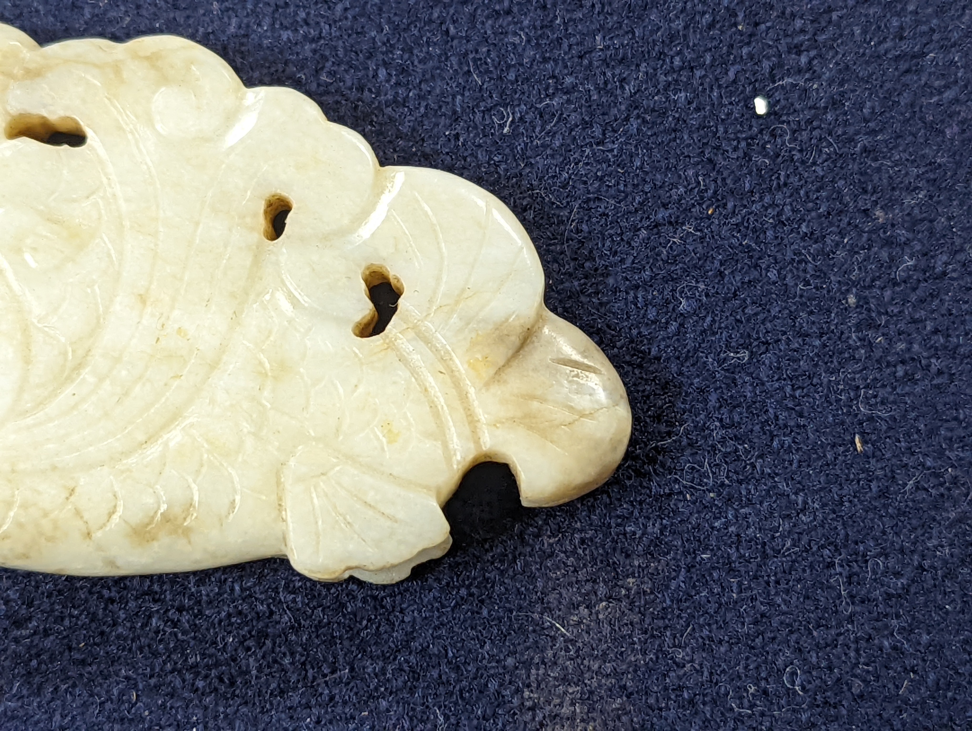 A Chinese white and black jade ‘dragon-fish’ plaque, 19th/20th century, 6cm